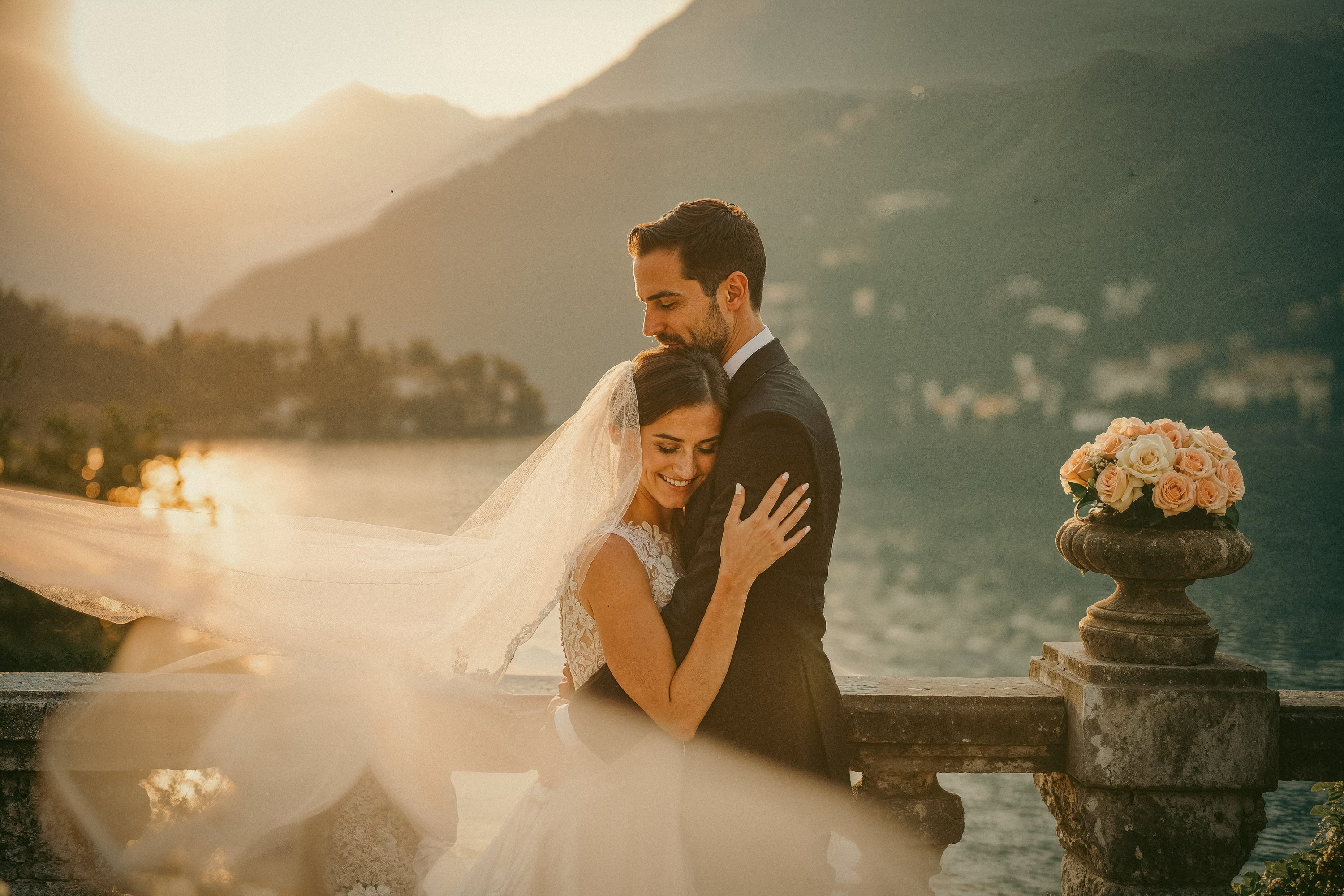 Couple embracing in golden hour at Italian villa, luxury destination wedding